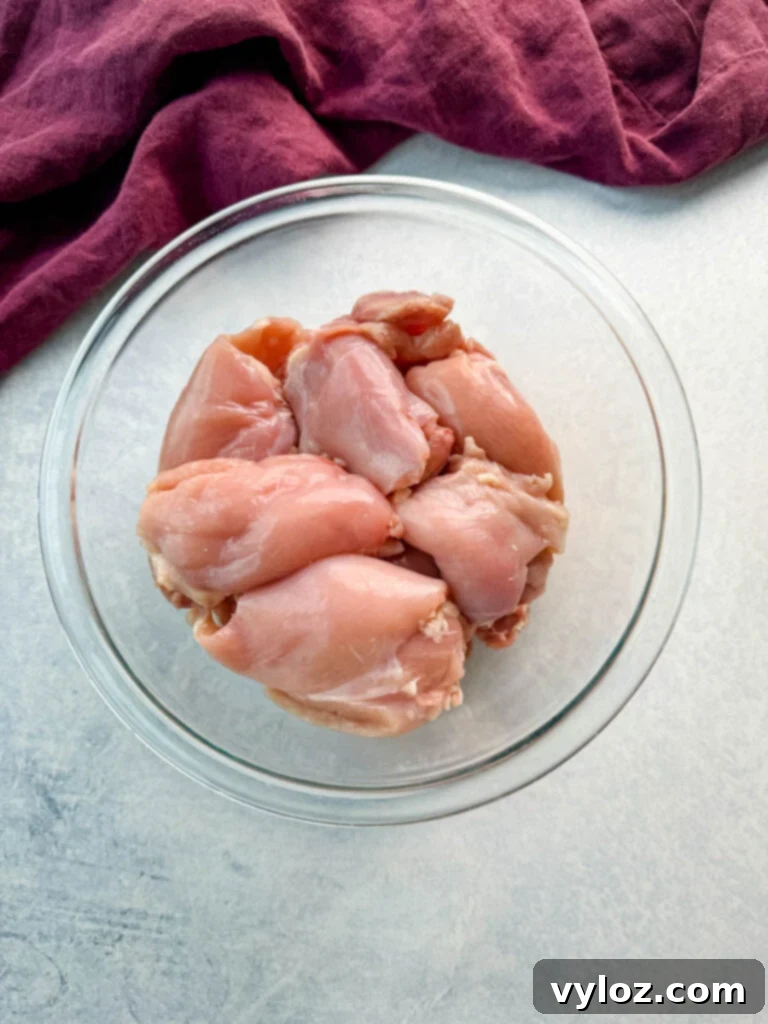 raw skinless, boneless chicken thighs in a glass bowl