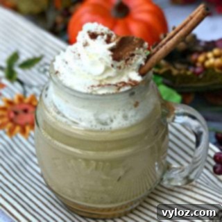 Instant Pot Skinny Pumpkin Spice Latte in a glass mug with whipped cream and cinnamon