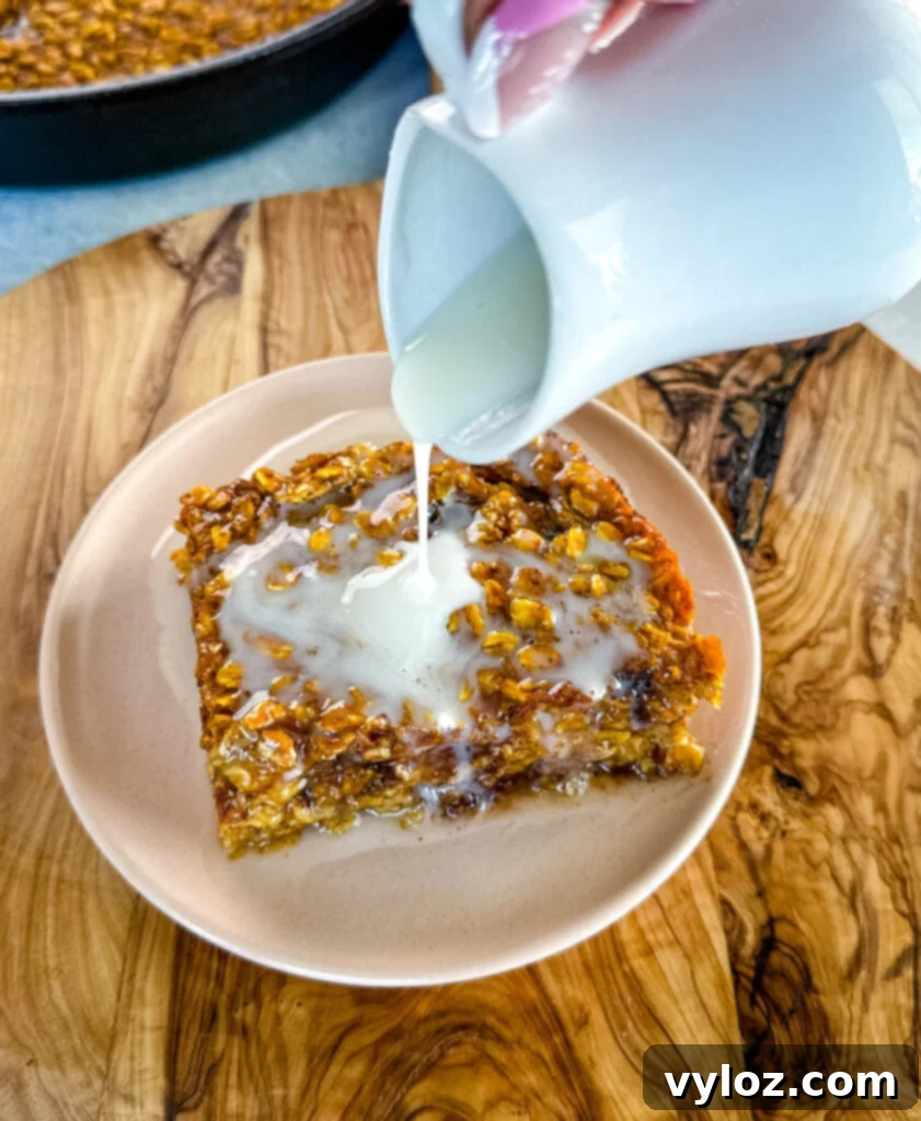pumpkin baked oatmeal with on a plate drizzled with icing