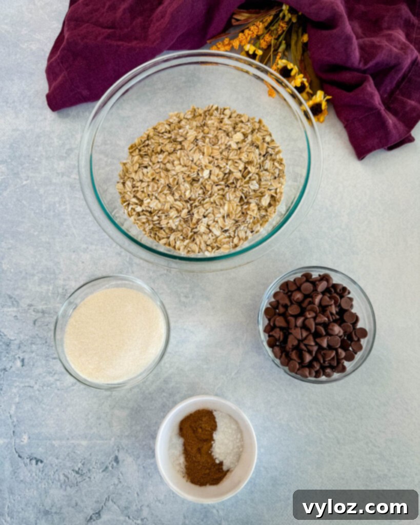 rolled oats, sweetener, chocolate chips, and pumpkin pie spice in separate bowls