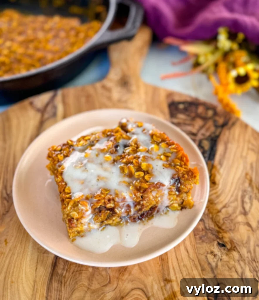 pumpkin baked oatmeal with on a plate drizzled with icing
