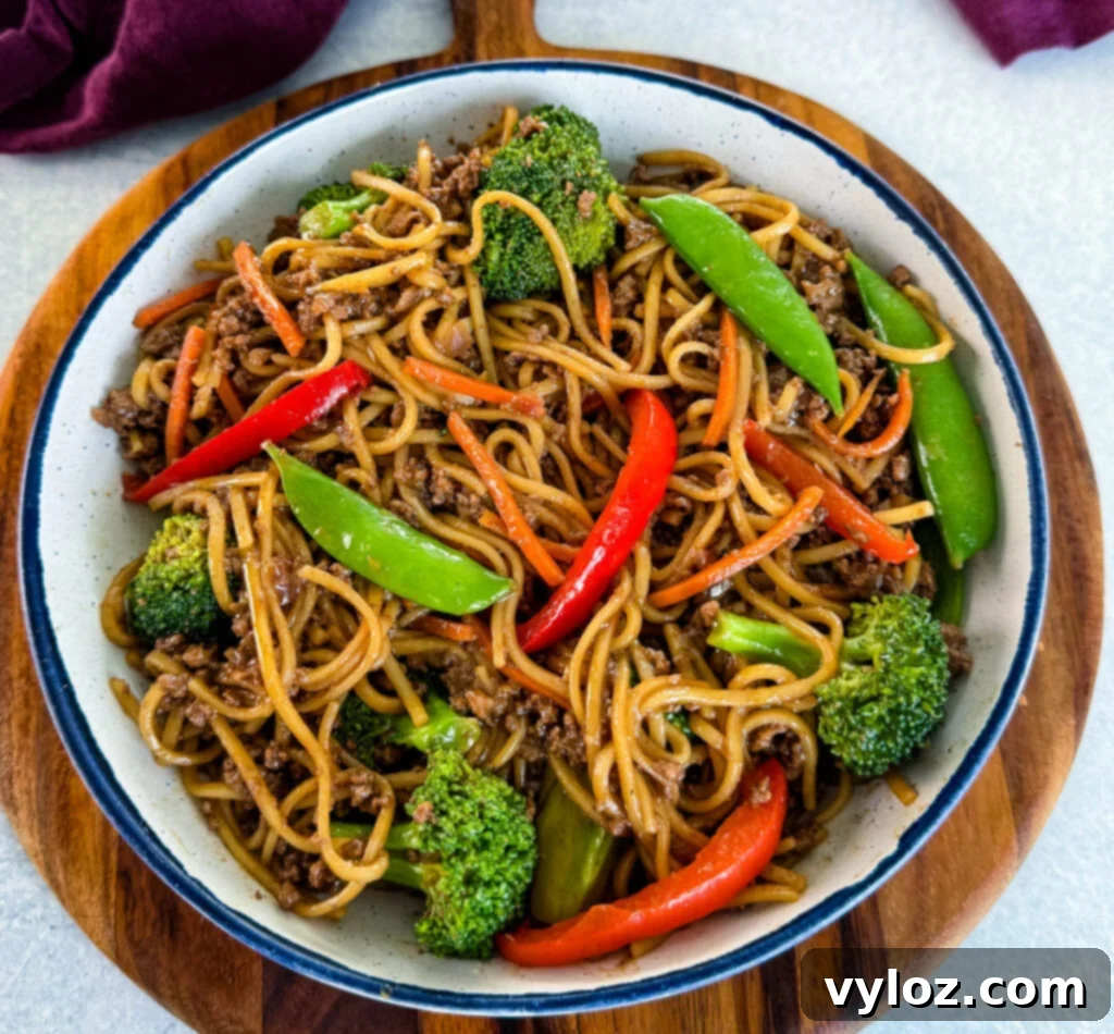 Flavorful Homemade Ground Beef Lo Mein 2 Ground beef lo mein and vegetables in a white bowl, ready to be served