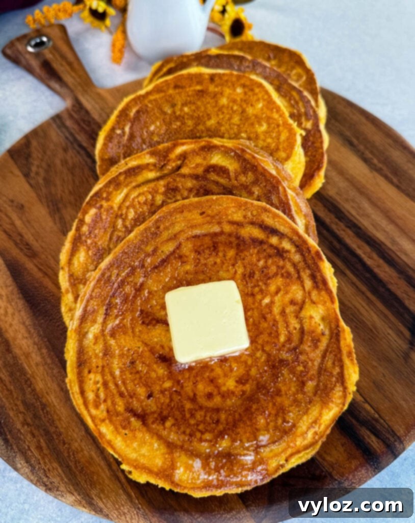 Crispy Golden Fried Cornbread 2 fried cornbread with butter on a plate