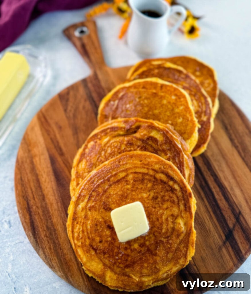 Crispy Golden Fried Cornbread 12 fried cornbread with butter on a plate