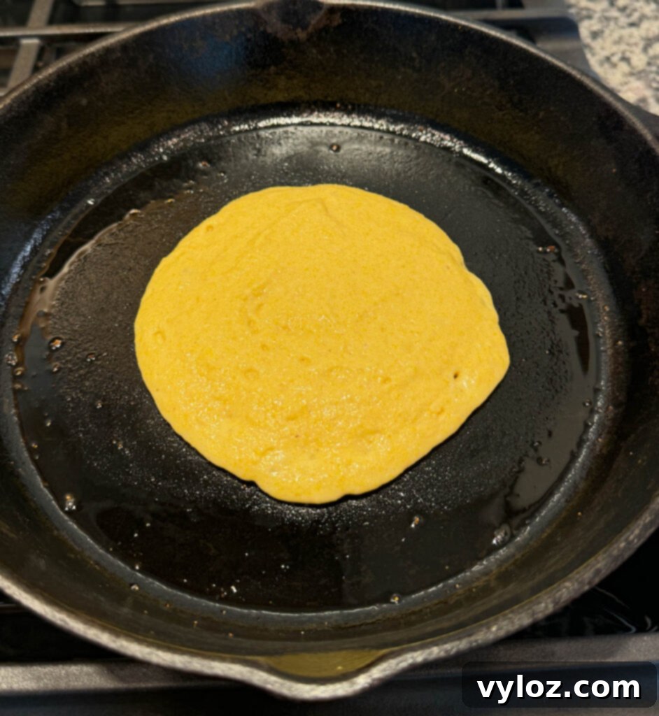 Crispy Golden Fried Cornbread 6 fried cornbread in a cast iron skillet