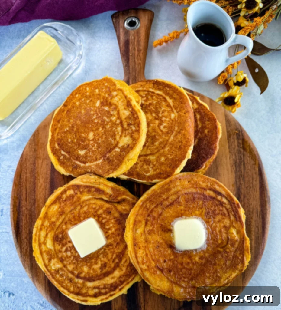 Crispy Golden Fried Cornbread 8 fried cornbread with butter on a plate