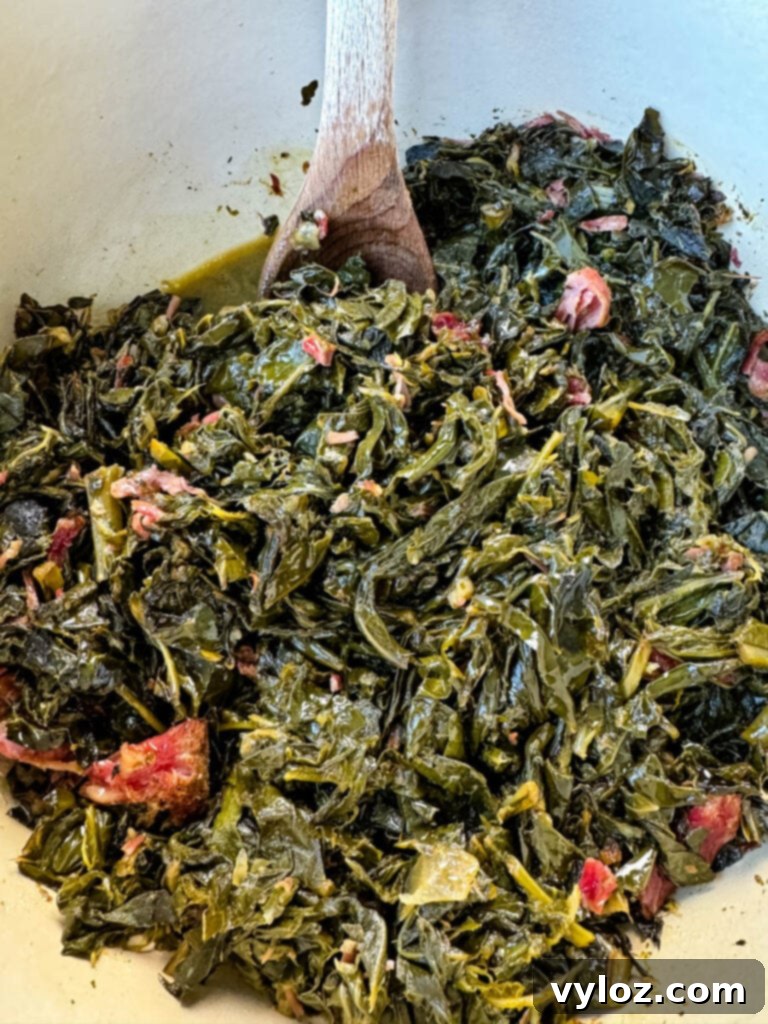 collard greens and ham hocks in a Dutch oven
