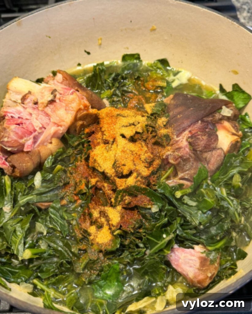 collard greens, spices, and ham hocks in a Dutch oven