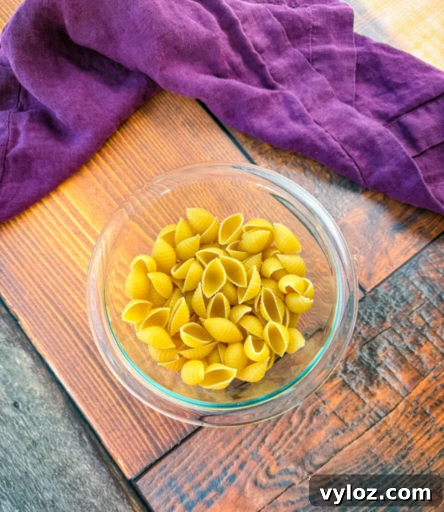 uncooked shells pasta in a glass bowl
