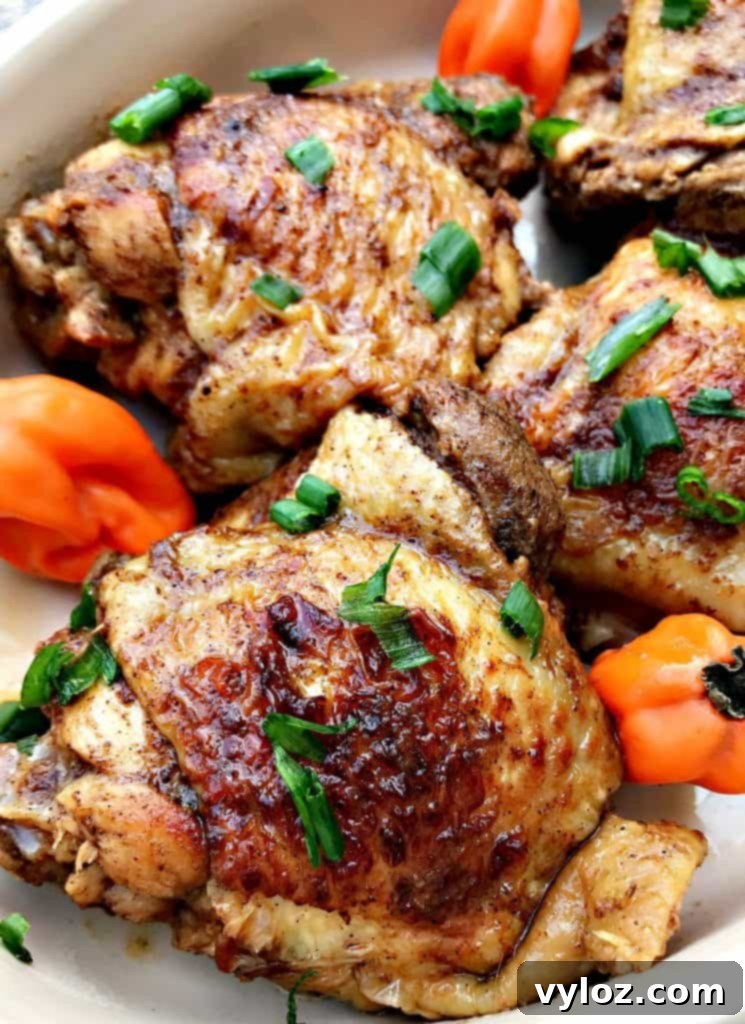 Flavorful Instant Pot Jamaican Jerk Chicken Thighs 5 Raw chicken thighs coated generously in spicy jerk marinade, ready for cooking.