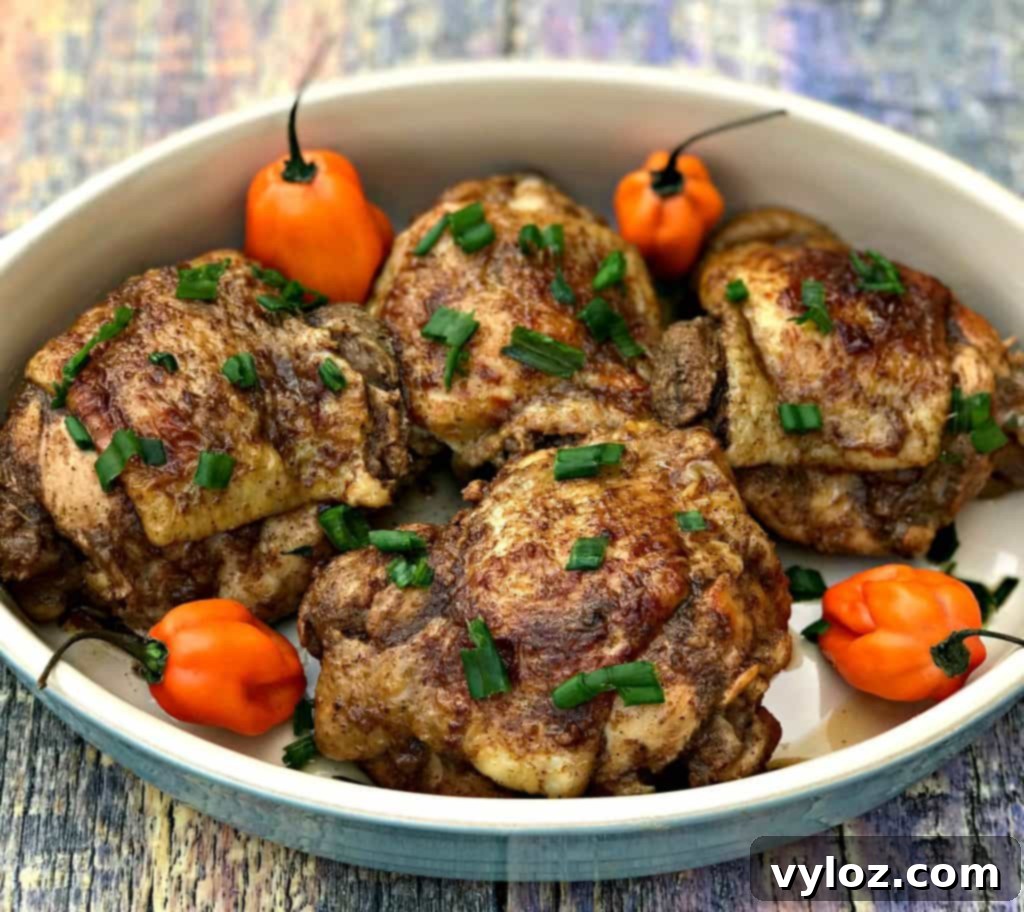 Flavorful Instant Pot Jamaican Jerk Chicken Thighs 7 A stack of perfectly cooked Instant Pot Jamaican jerk chicken thighs on a plate, ready to be served.