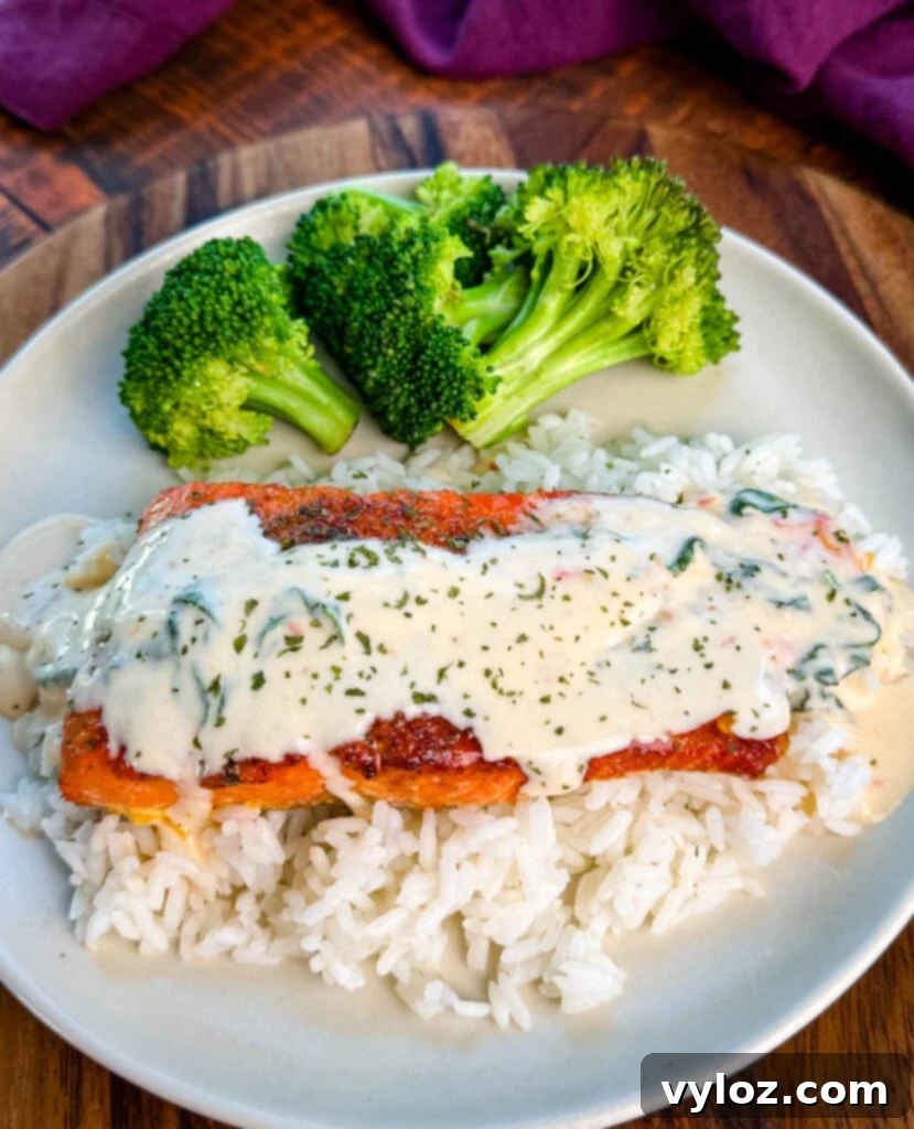 Tuscan style marry me salmon with cream sauce with rice and broccoli on a plate