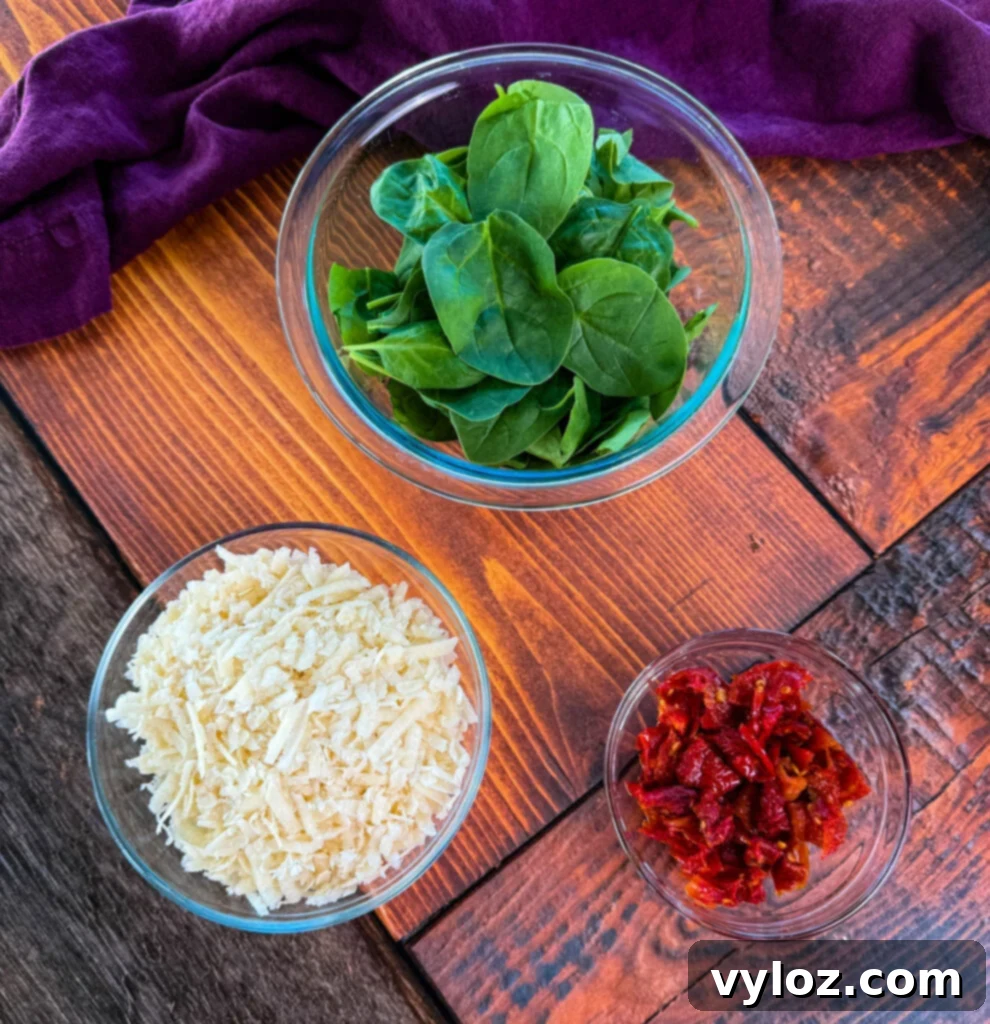 spinach, Parmesan reggiano cheese, and sundried tomatoes in separate bowls