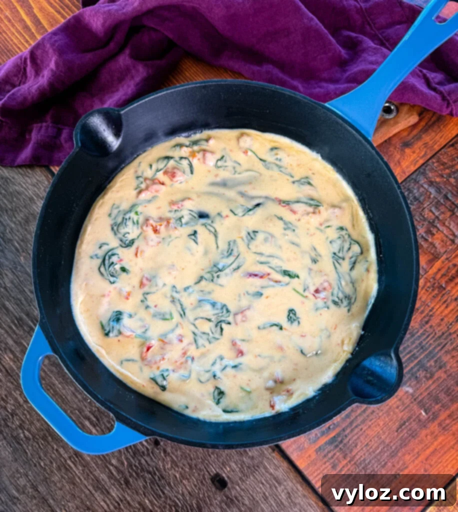 Tuscan marry me cream sauce in a blue skillet