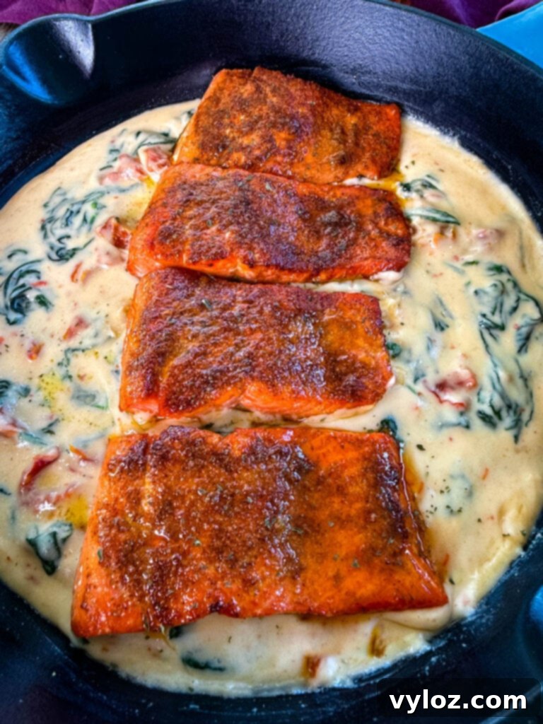 Tuscan style marry me salmon with cream sauce in a skillet