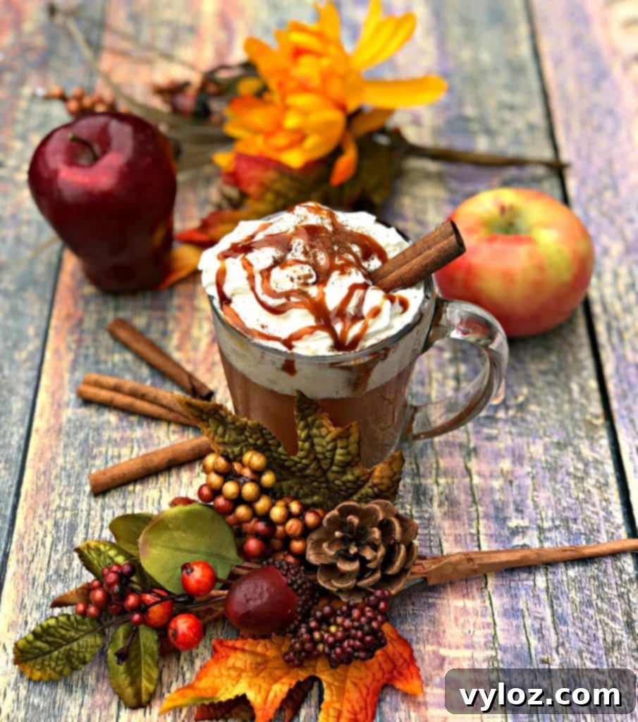 Close-up of fresh apples and cinnamon sticks, key ingredients for homemade apple cider.