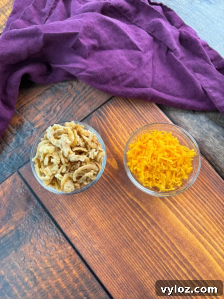 Creamy Green Bean Delight 5 fried onions and grated cheddar cheese in separate glass bowls