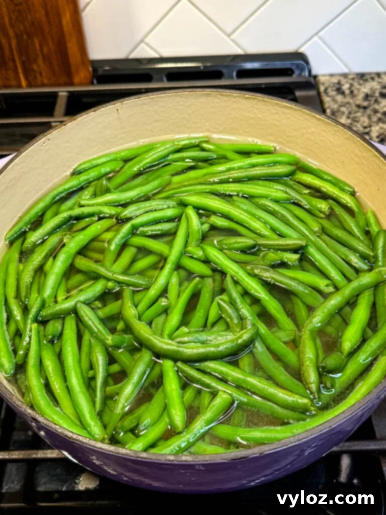 Creamy Green Bean Delight 8 blanched green beans in boiling water in a Dutch oven on the stove