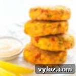 Quick and Crispy Air Fryer Crab Cakes 11 air fryer crab cakes on a white plate with fresh lemon