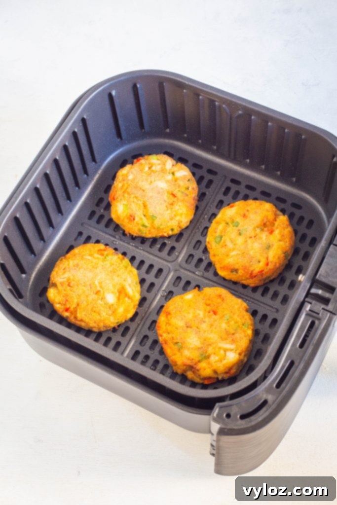 Quick and Crispy Air Fryer Crab Cakes 8 A batch of perfectly air-fried crab cakes, golden and crispy, nestled in the air fryer basket