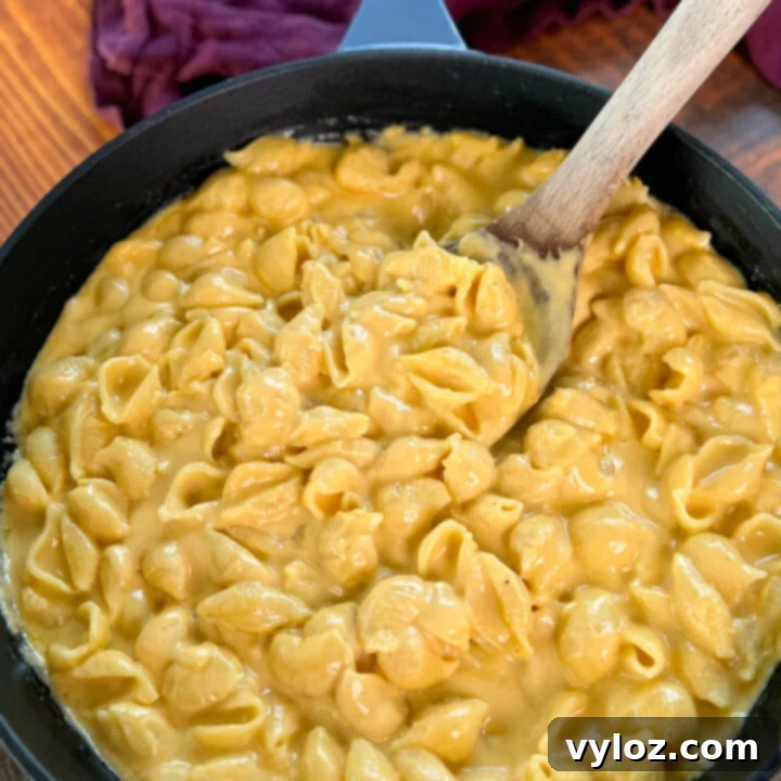 A steaming bowl of simple stovetop mac and cheese, showcasing its creamy texture and rich, golden cheese sauce, ready to be served.