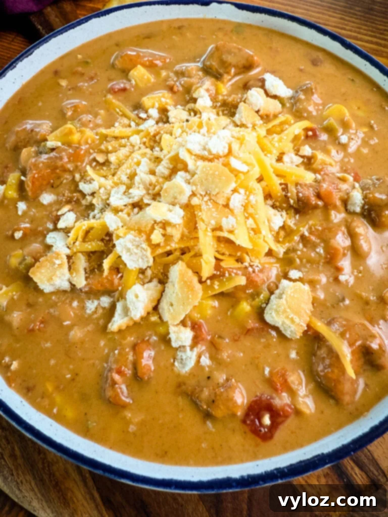 Protein-Packed Chicken Chili 11 high protein chicken chili in a white bowl with crackers and a spoon