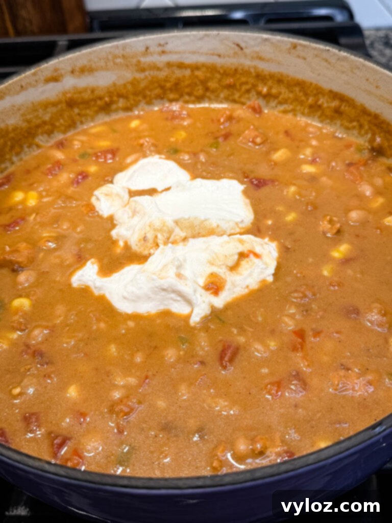 Protein-Packed Chicken Chili 7 high protein chicken chili in a pot with plain Greek yogurt
