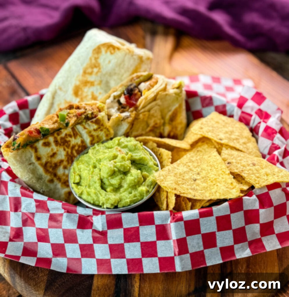 Ultimate Creamy Protein Chicken Burrito 9 High-Protein Chicken Burritos served with guacamole and chips, showing a crispy exterior