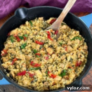 marry me chicken and rice in a pan with a wooden spoon