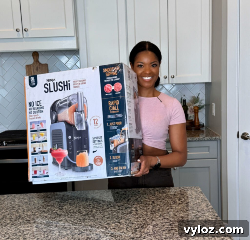person holding Ninja slushi box in a kitchen