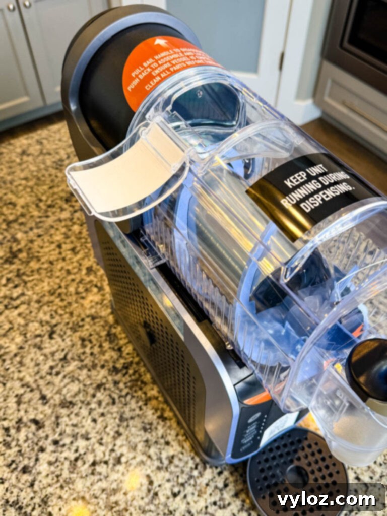 Top-Down View of the Ninja SLUSHi Machine’s Mixing Chamber – A view of the clear chamber lid, showing the internal blue auger that churns the liquid into slush.