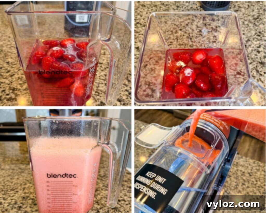 A Blendtec blender filled with strawberries and liquid before blending,
