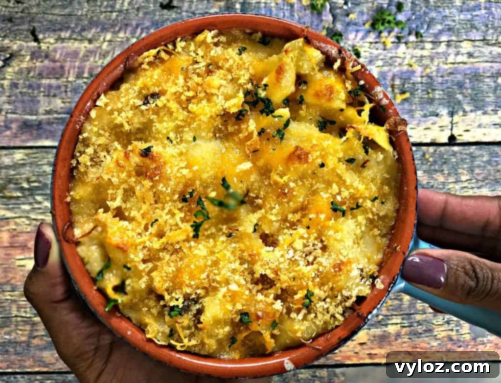 Caramelized Onion Mushroom Mac and Cheese Bake 8 Serving spoonful of cheesy Baked Macaroni and Cheese with caramelized vegetables