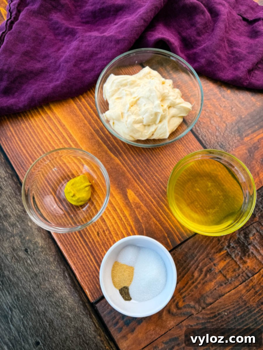 Dill-icious Creamy Potato Salad 4 A flat-lay image displaying small glass bowls with ingredients for the salad dressing. The bowls contain mayonnaise, yellow mustard, pickle juice, and a blend of seasonings including salt, pepper, and garlic powder. The wooden surface and purple cloth create a rustic background.