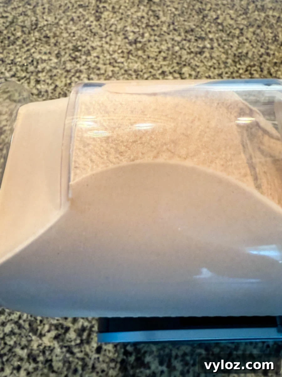 A close-up of the machine, showing the frozen chocolate mixture thickening as it processes.