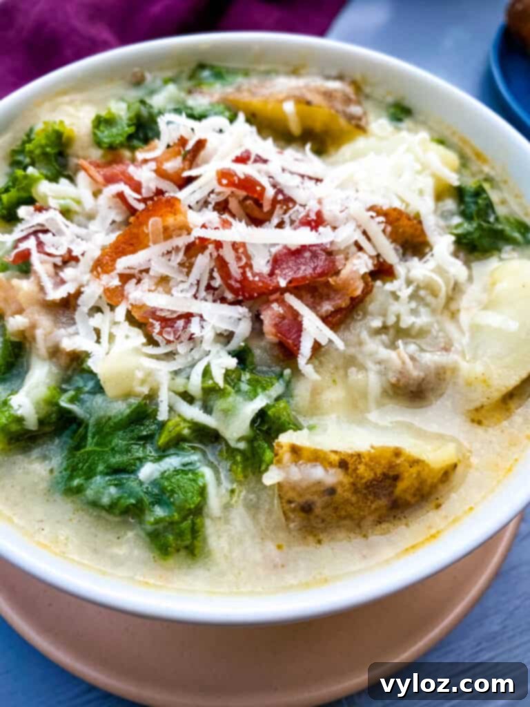 Close-up of creamy Zuppa Toscana soup, showing rich broth, tender potatoes, and vibrant kale