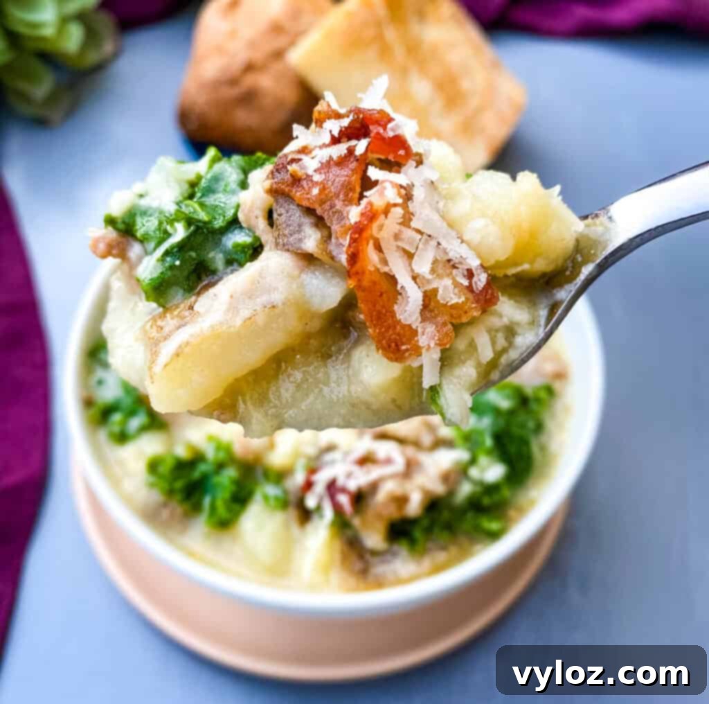 A spoonful of delicious Instant Pot Zuppa Toscana Soup, highlighting its hearty ingredients
