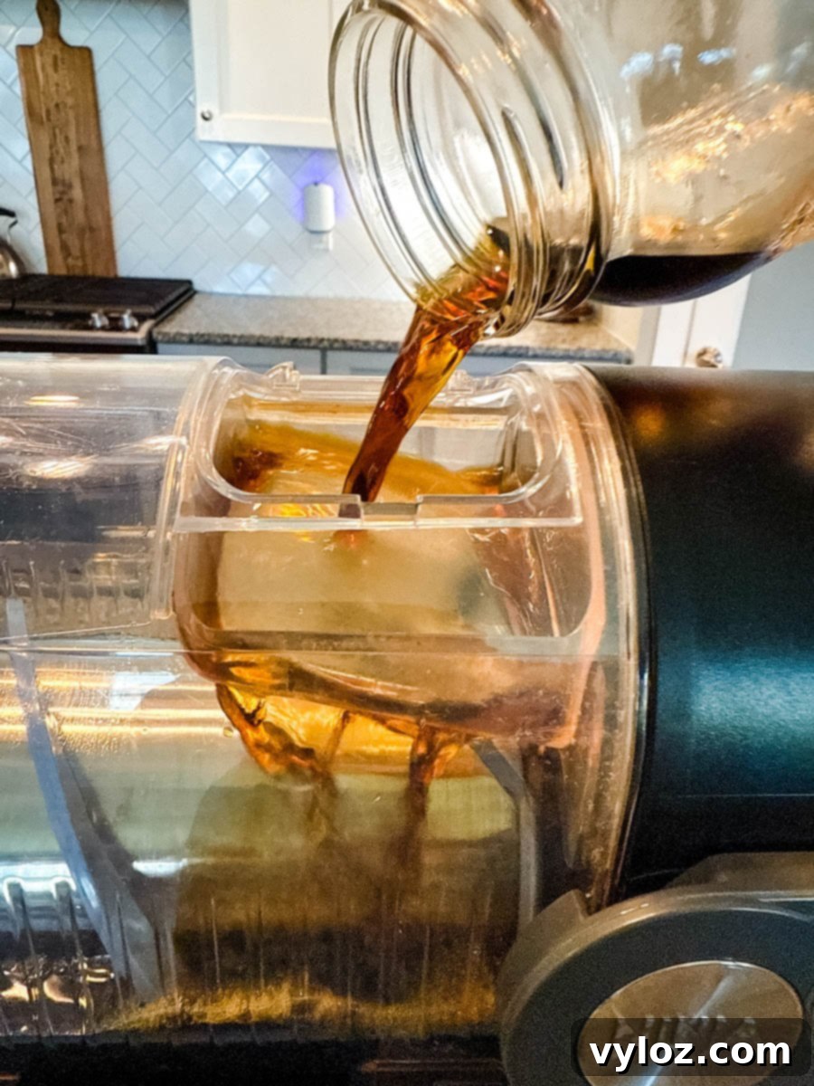 Frozen Shadow Espresso Martini 4 Coffee mixture being poured from a mason jar into the Ninja Slushi machine.