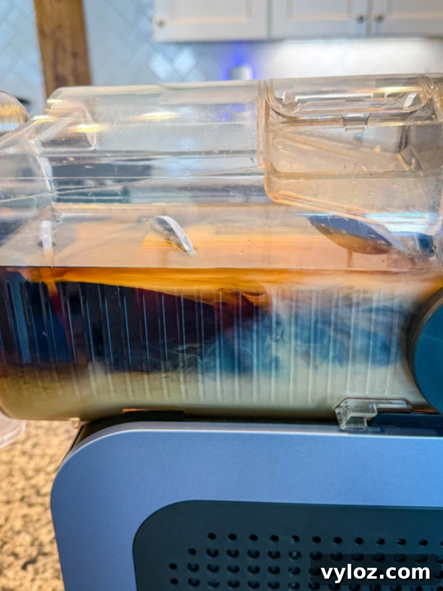 Frozen Shadow Espresso Martini 5 Side view of the Ninja Slushi machine in action, showing espresso martini mixture churning inside.