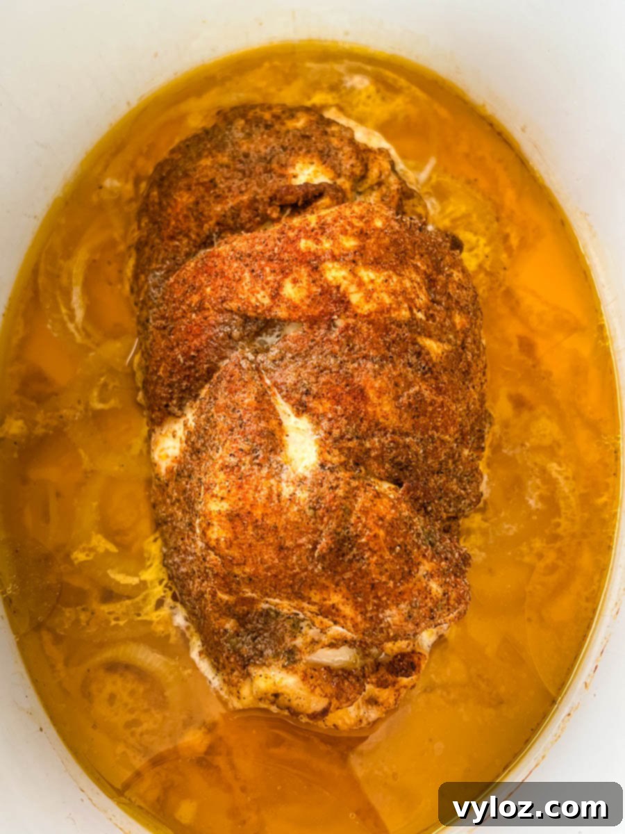 slow cooker boneless turkey breast sliced in a Crockpot