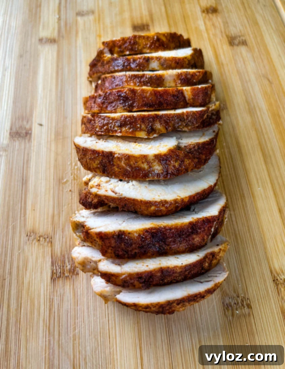 slow cooker Crockpot boneless turkey breast sliced on a bamboo cutting board