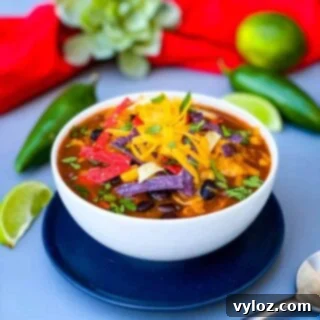 Instant Pot Chicken Tortilla Soup in a white bowl, garnished