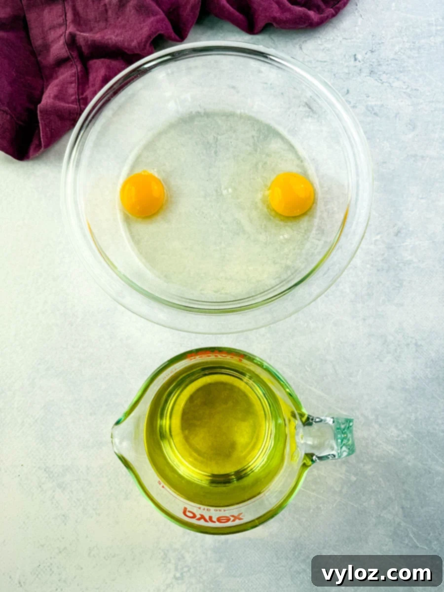 raw eggs and canola oil in separate glass bowls