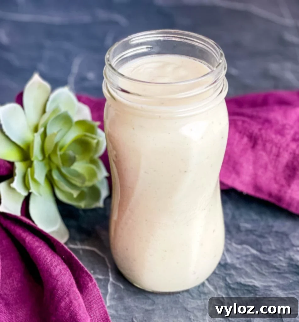 Homemade cream of chicken soup stored in a clear glass mason jar, showcasing its freshness and readiness for refrigeration.