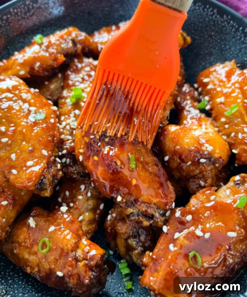 Sticky Honey Garlic Wings 11 honey garlic chicken wings drizzled with sauce with a cooking brush