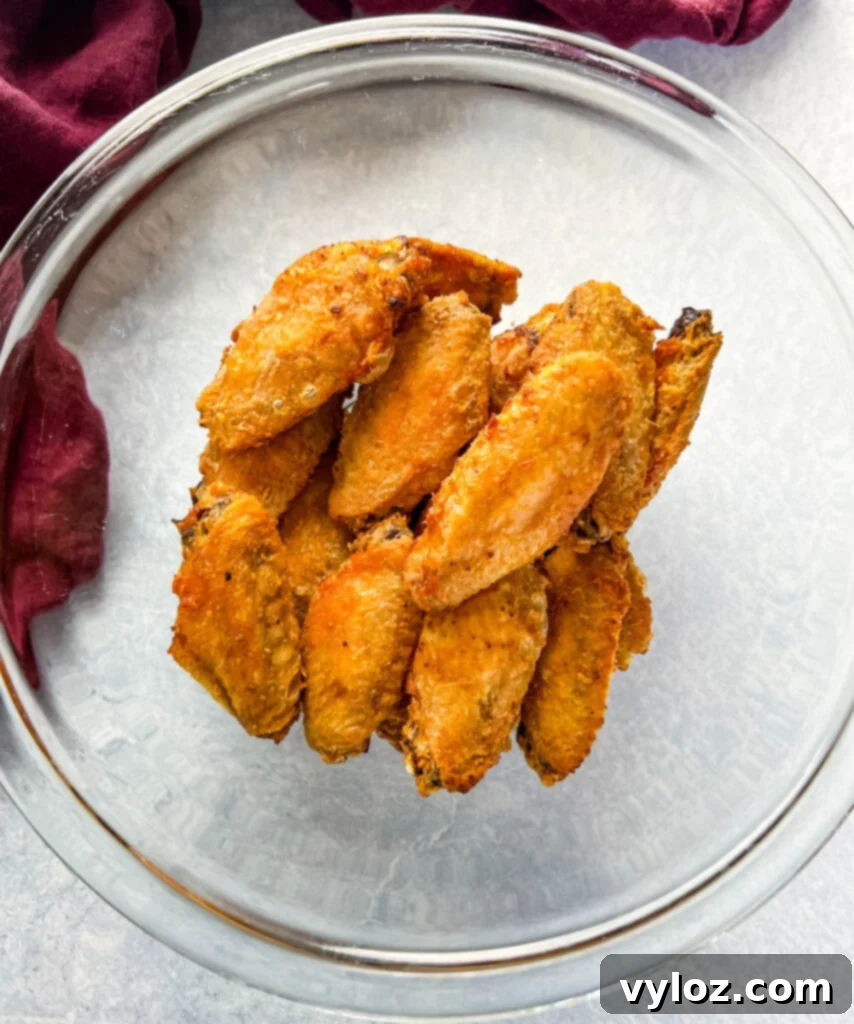 Sticky Honey Garlic Wings 8 breaded chicken wings in a glass bowl