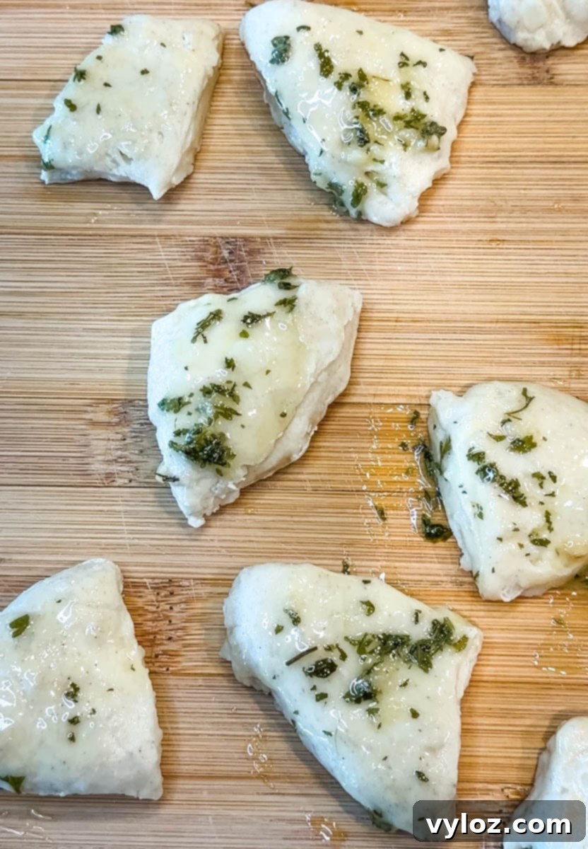 biscuit dumplings with butter and garlic on a cutting board