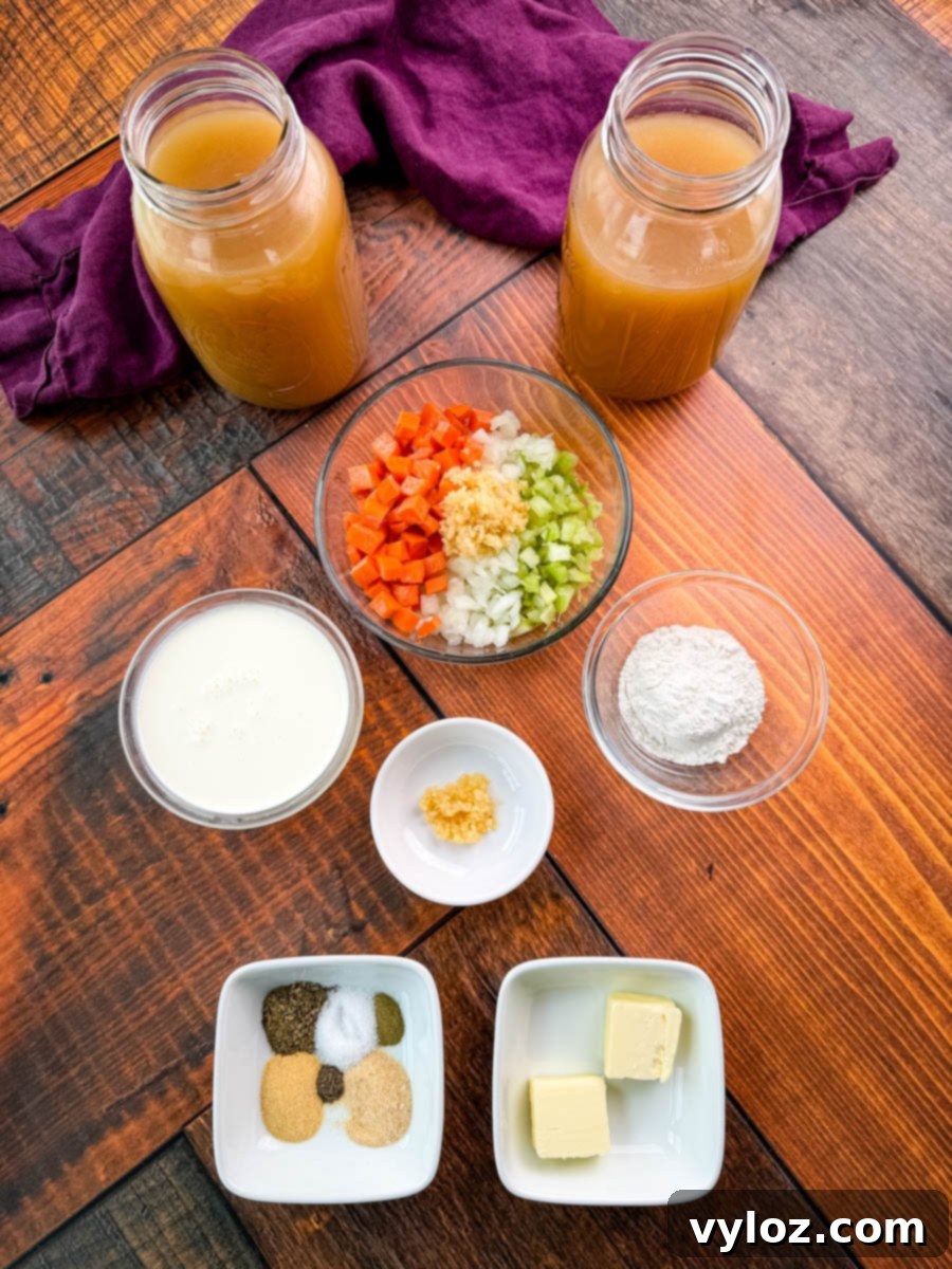 Fresh ingredients laid out for making chicken and dumplings, including a bag of frozen biscuits, butter, and herbs.