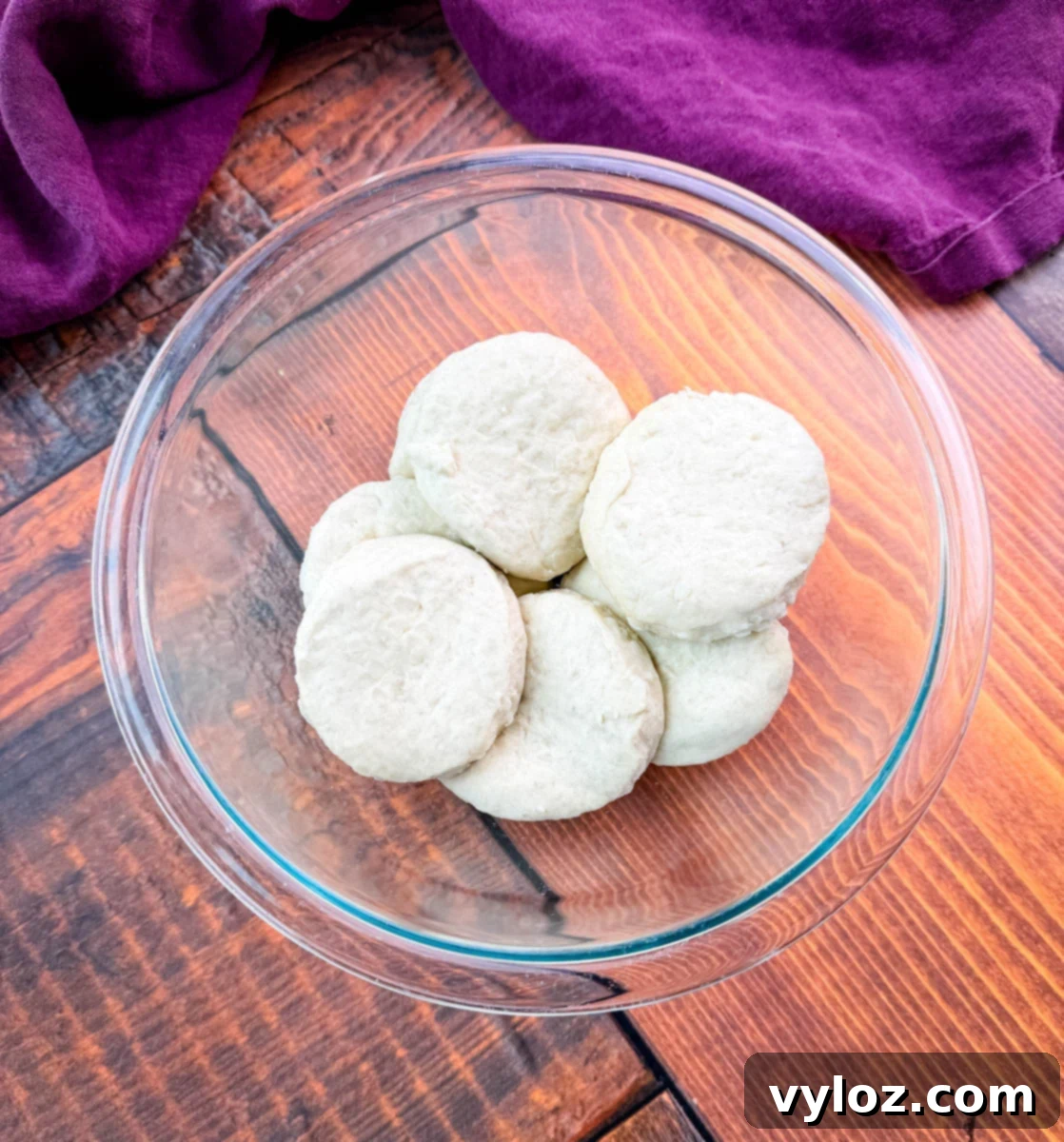 Assortment of fresh vegetables: diced carrots, celery, and onions, neatly arranged on a white cutting board.