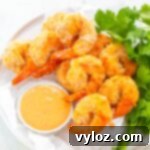 Crispy Air Fryer Bang Bang Shrimp 11 Air Fryer Bang Bang Panko Breaded Fried Shrimp on a white plate served with a spicy sweet chili sauce